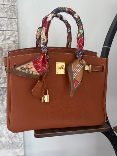 Customer's structured bronze LALUVA - Warkin Bag with colorful scarves wrapped on its handles.