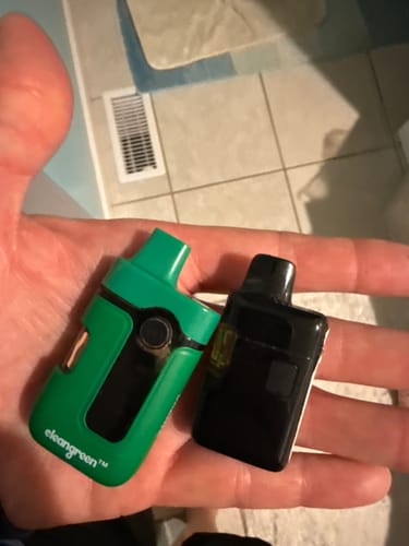 Customer holding a green Calm Vape and a newer, smaller black one for comparison.