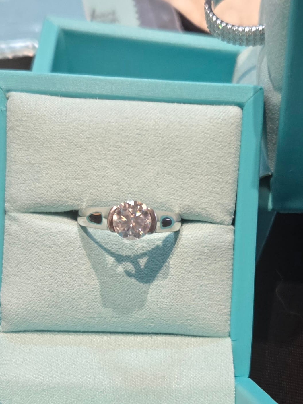 Customer photo review of Solitaire Moissanite Half Bezel Set Sterling Silver Engagement Ring