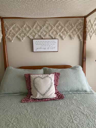 Reviewer's Goodness Of God Faith Sign, featuring its printed wood frame, centered on a wall over a bed.