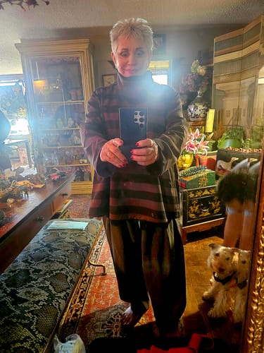 Reviewer takes a mirror selfie wearing the casual Stripe Turtleneck Sweatshirt, showing its loose, comfortable fit.