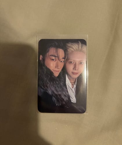 Reviewer's ATEEZ 'GOLDEN HOUR' photocard of two members, shown inside a clear protective sleeve.