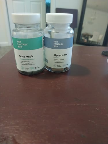 Customer's Slippery Box supplement bottle on a table next to another product from the same brand.