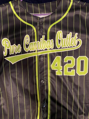 Customer's custom black pinstripe jersey with neon green text 'Pure Cannibas Outlet' and '420' on the front.