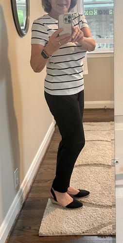 Customer taking a mirror selfie showing the tapered fit of the black Nicole Ankle Pants from the side.