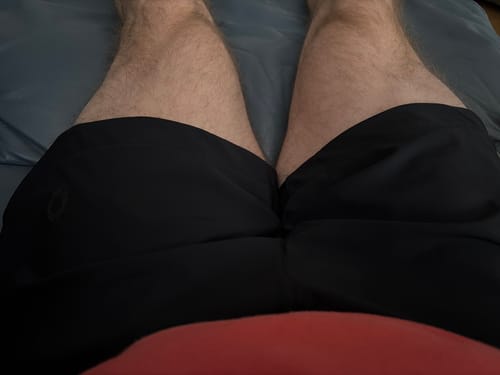 Customer's first-person view of the black Core Hybrid Shorts, showing the fit and length on their thighs.