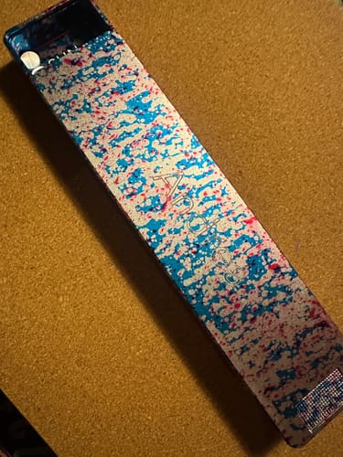 Reviewer's colorful speckled Weekly Case shown closed on a corkboard.