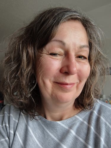 Kundin zeigt ihr natürlich gewelltes Haar nach der Anwendung der Camilla-Calma Haarseife.