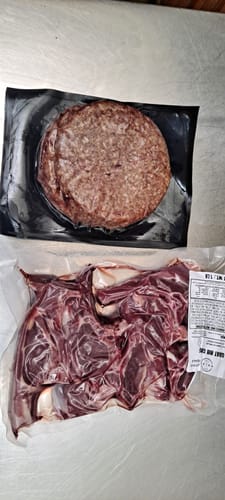 Reviewer's vacuum-sealed package of fresh Halal Goat Rib Chops on a counter.