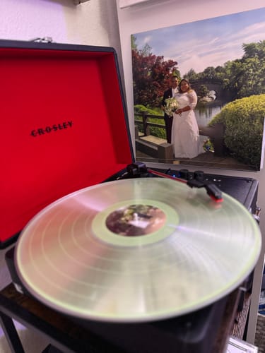Customer's clear custom vinyl record with a personalized photo label playing on a turntable.
