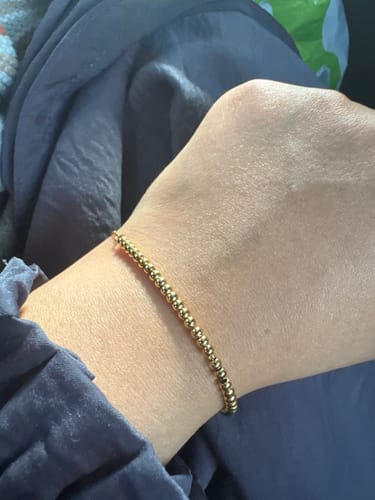 Reviewer showing the delicate, gold-beaded Dainty Tasbih Bracelet on their wrist.