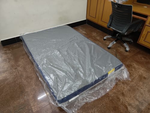 Customer's new Flo Anti-Gravity™ Natural Latex Mattress in its plastic wrapping on the floor.