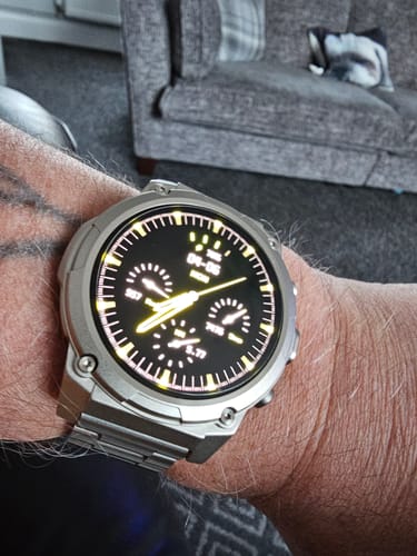 Customer's silver Gard Pro Ultra 3 on their wrist, showing the metal band and a bright, detailed watch face.