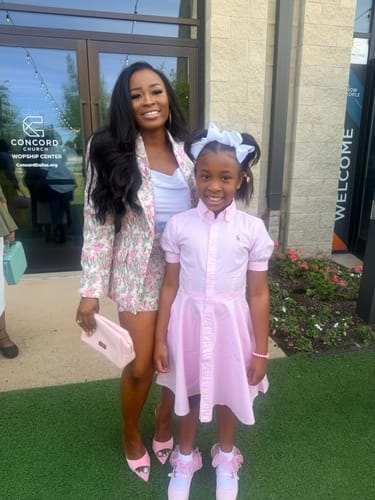 Reviewer in the full floral jacquard suit, wearing the mini skirt with the matching blazer outdoors.