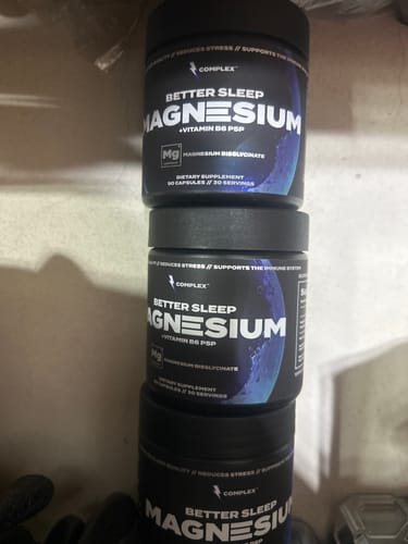 Customer's three black tubs of Better Sleep Magnesium supplement stacked together on a shelf.