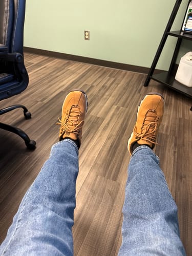 Customer's point-of-view showing their brown ST329 CMF shoes worn with jeans in an office.