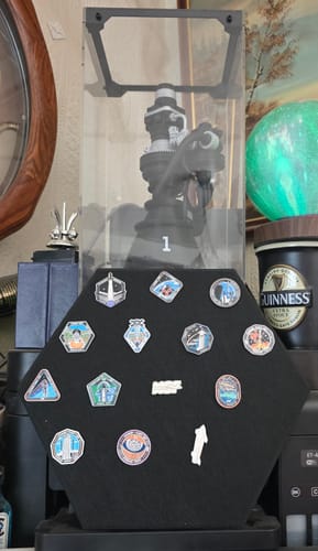 Customer's Starship Flight Pin Collection arranged on the hexagonal black felt display mount, shown on a desk.