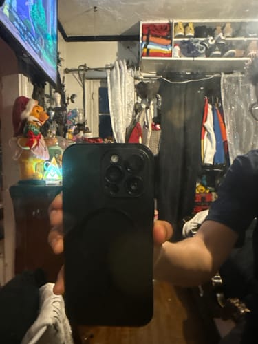 Reviewer showing the back of their iPhone, protected by the black MagCase Metal case.