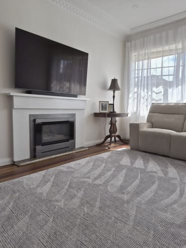 Customer's Mellow Mat with a pebble-weave design laid out in a bright living room.