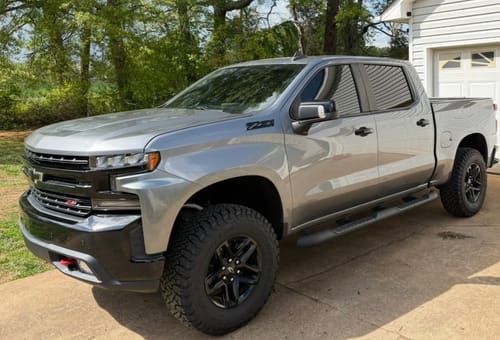 Reviewer's silver Chevy Silverado with 1.5" wheel spacers installed, showing a wider, more aggressive stance.