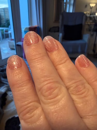 Customer's hand showing a shimmery pink manicure using the Holy Gels Starter Kit.