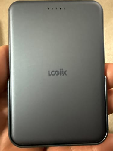 Customer holding the compact, gray Piston Power 5000 Stance Mag power bank.