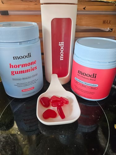 Customer's daily routine with the Strawberry Watermelon blend, another moodi product, a shaker, and some red gummies.