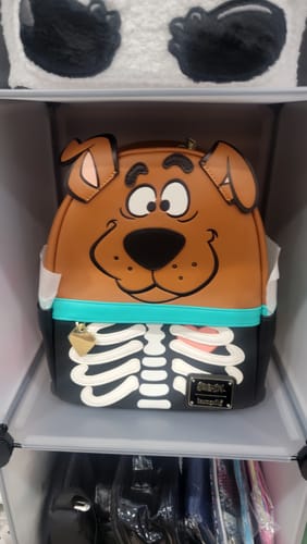 Customer shows a Scooby-Doo Loungefly mini backpack from their mystery box, featuring a skeleton design on the bottom.