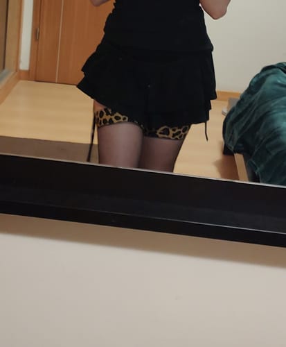 Reviewer wearing the Leoparda Black Sheer Thigh High Stockings under a black mini skirt.
