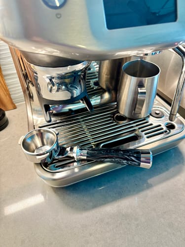 Customer's beautiful Italian Handle Bottomless Portafilter with a marbled handle, shown on an espresso machine.