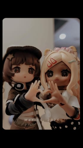 Customer's two Electronic Pet Game BJD dolls, one with brown hair and one blonde, posing to form a heart with their hands.