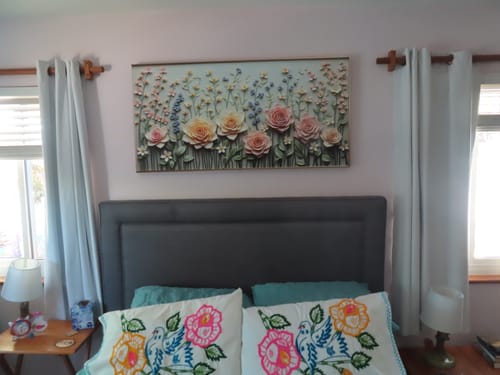 Customer's Garden Rhapsody Impasto Wall Art hanging above a bed with a grey headboard.