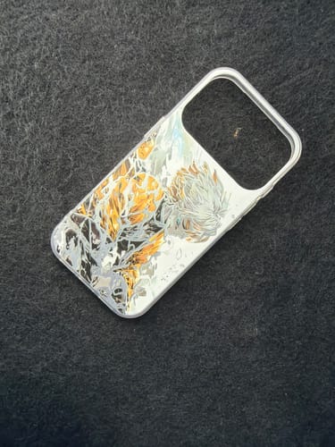 Customer's glossy Zenitsu - Demon Slayer phone case with detailed artwork laid on a dark surface.