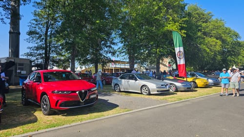 Reviewer's shiny red car on display at a car show, cleaned with the Waterless Wash / Detailer.
