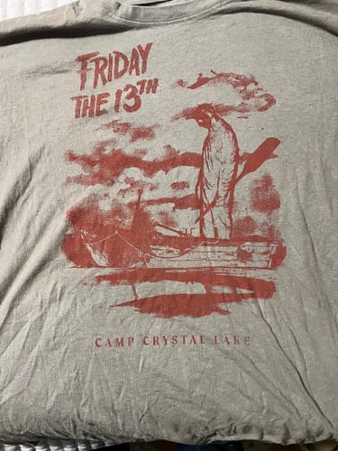 Customer's grey TV & Movie t-shirt with a red "Friday the 13th" graphic showing a character in a boat at Camp Crystal Lake.