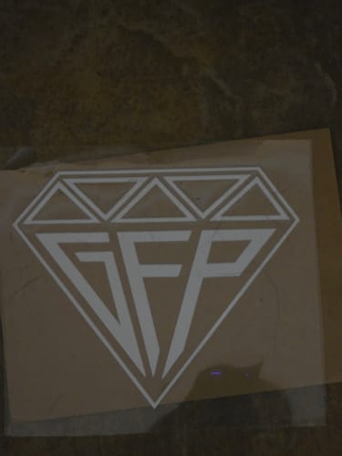 Customer's white GFP Premium Decal, shaped like a diamond, shown on its backing paper.