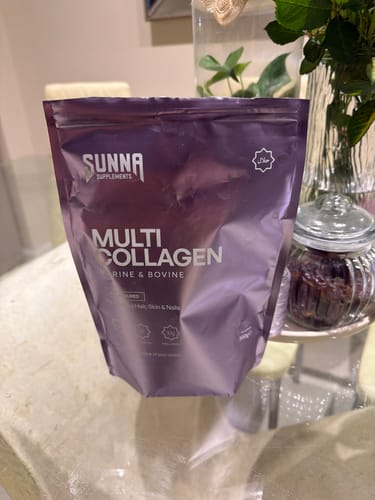 Customer's purple bag of Sunna Supplements Multi Collagen sitting on a glass table.