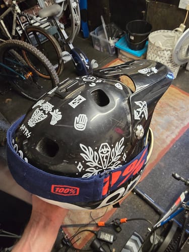 Customer holding a black full-face helmet decorated with white Occult Transfer Decals.