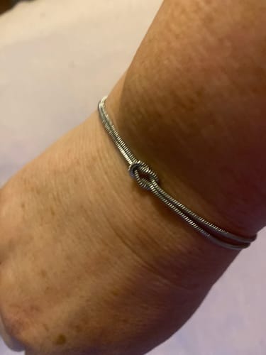 Customer's close-up of the silver Forever Knot Bracelet on their wrist.