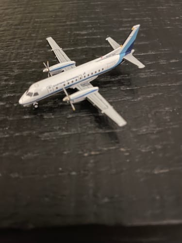 Customer's GEMINI EASTERN EXPRESS SF-340 model airplane sitting on a dark wooden surface.
