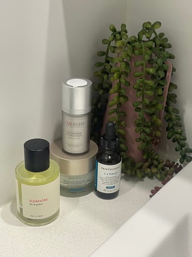 Customer's bottle of Eleanore perfume displayed on a counter with other skincare products.