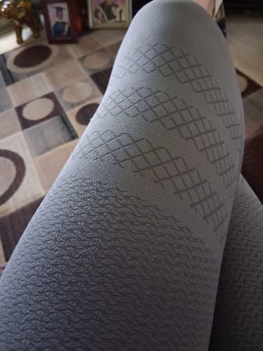 Close-up of a customer wearing the grey 3D Anti-Cellulite Leggings, detailing the textured, patterned fabric on the leg.