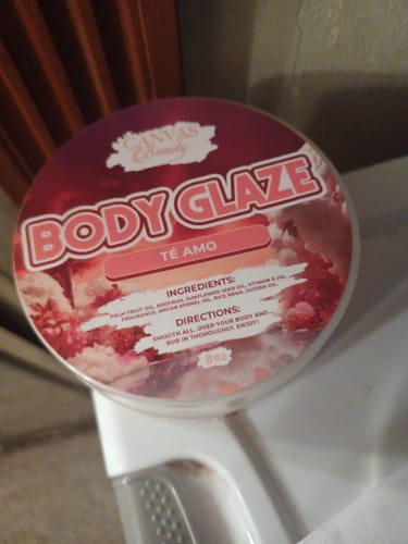 A customer's large jar of Body Glaze in the Te Amo scent, showing a top-down view of the colorful lid.