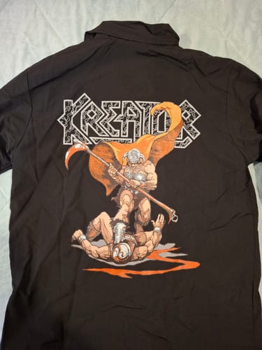 Reviewer's black Kreator Endless Pain windbreaker laid out, showing the colorful graphic print on the back.