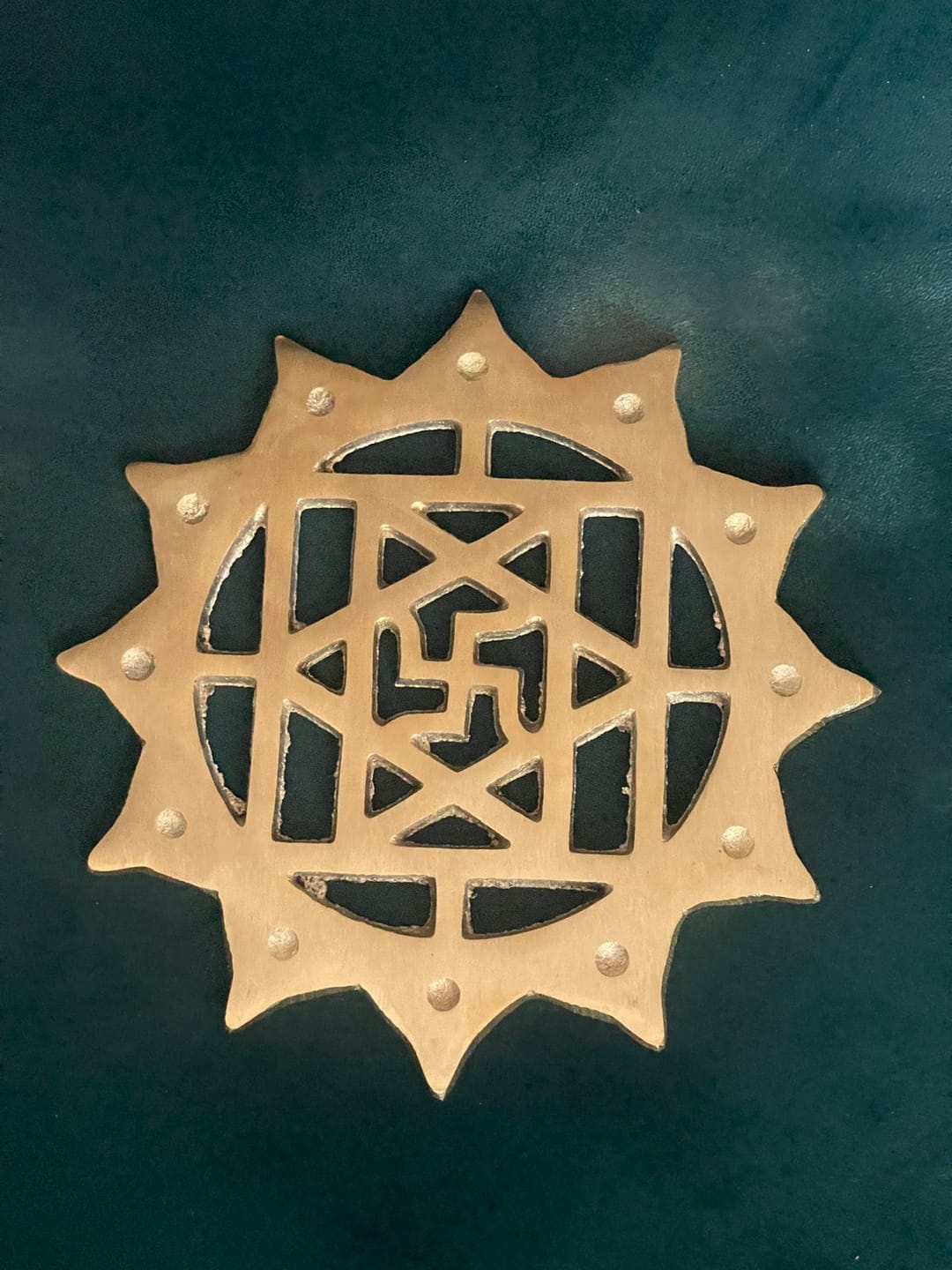 Customer photo review of Brass Swastik with Lotus Helix – Vastu Remedy for Main Door Protection | Evil Eye & Positive Energy Shield | Kitchen/Entrance Placement | 6 x 6 Inch