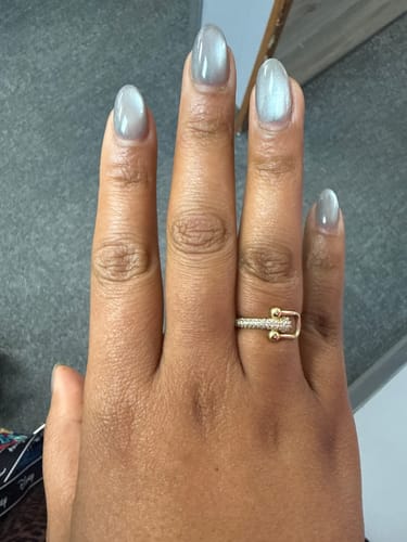 A customer's hand wearing the 14K Woman’s TF Link CZ Ring, showing its paved stone details.