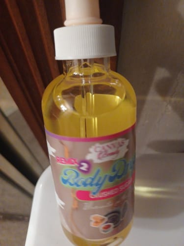 Customer's close-up view of the Body Drops: Remix 2 Crushed Sugar bottle, showing the golden liquid and white dropper.