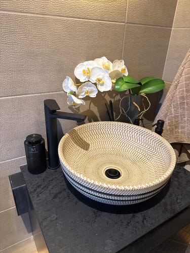 Customer's black MistMini diffuser sits on a bathroom counter, highlighting its compact size.