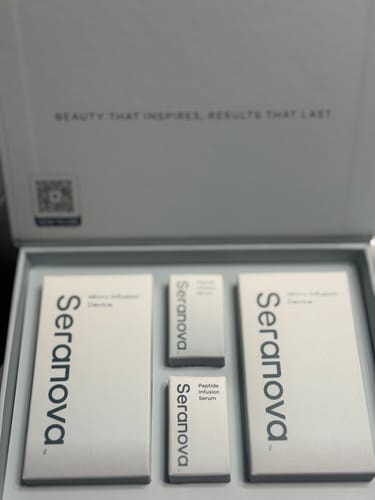 Customer's opened Seranova Microneedling Infusion System kit showing the packaged components neatly arranged inside the box.
