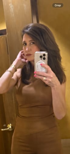 Reviewer taking a mirror selfie in the brown Faux Suede Ruched Sleeveless Top.